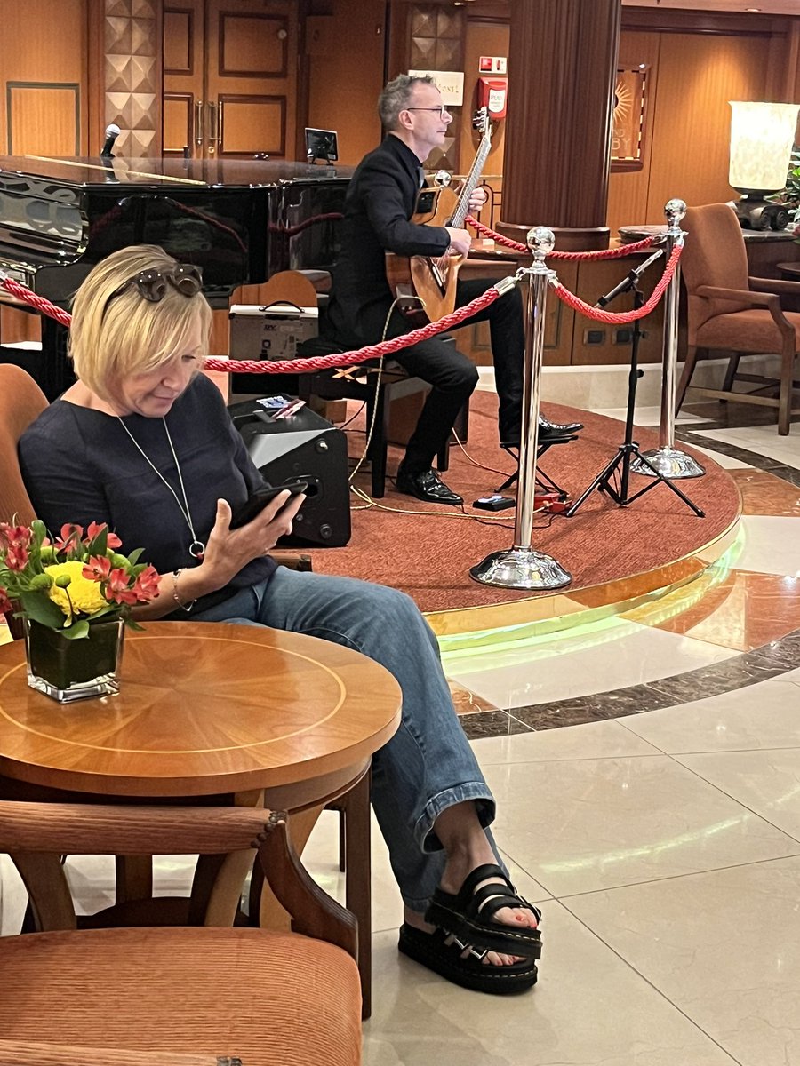 kathleengreg's tweet photo. Reading while listening to a classical guitarist 
@SandwichJunior https://t.co/tnXh8xFfTC