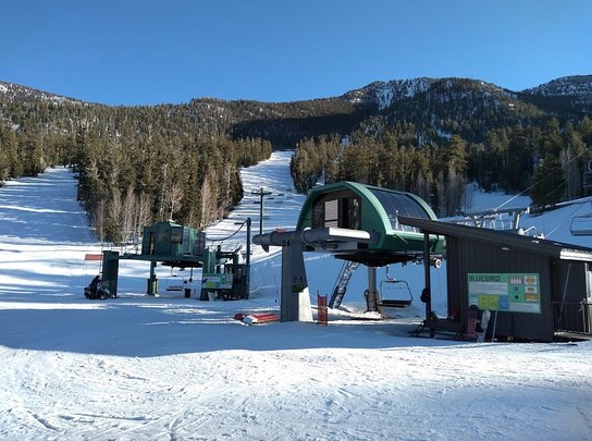 RenoFireWxIMET's tweet photo. Incredible debris flow/flooding damage from #Hilary.  That ski lift is buried in about 10 feet of mud and rock.  Here's what it's supposed to look like vs. today. @NWSVegas https://t.co/ZWH9nvRdFp