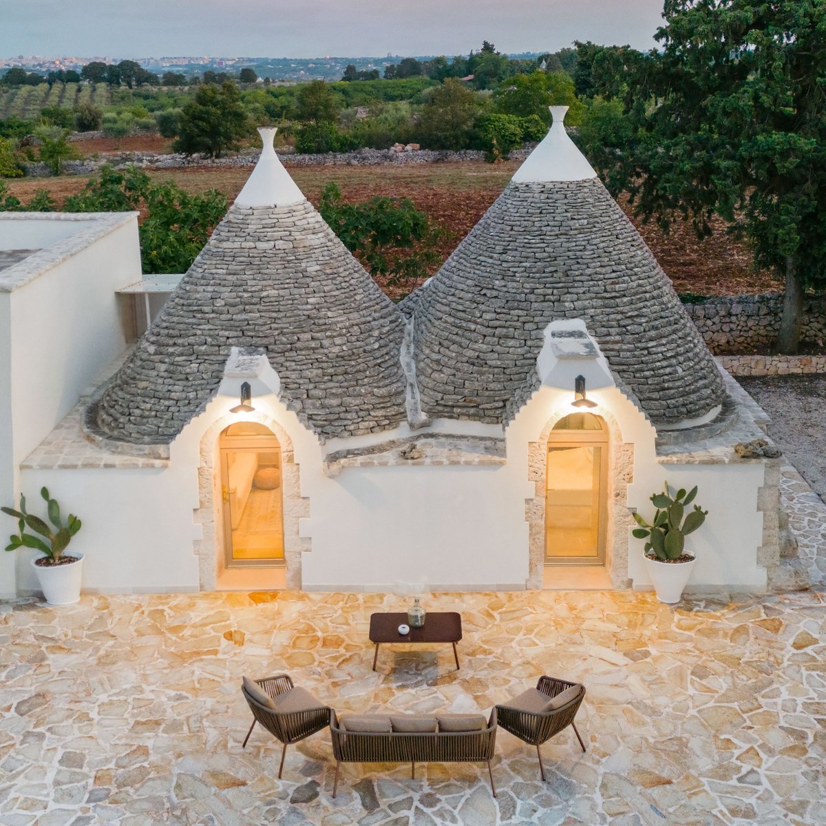 Airbnb's tweet image. a trullo is a traditional dry stone hut with a conical roof. do you know the only place you can find these? (no googling)