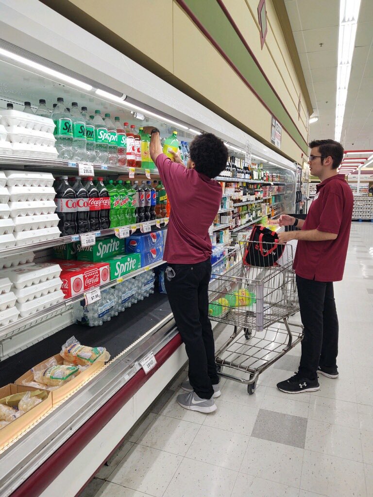 JoreeMorris's tweet photo. Another one of our amazing community partnered business is Butera. Here a couple of our young adults are learning to stick the cooler and outdate products. Working closely with local businesses, we can ensure our #granttransitionprogram  students get the best #workexperiences https://t.co/TFh9Qxurod