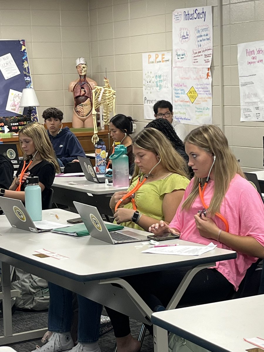 Allied health students learning how to listen for an apical pulse