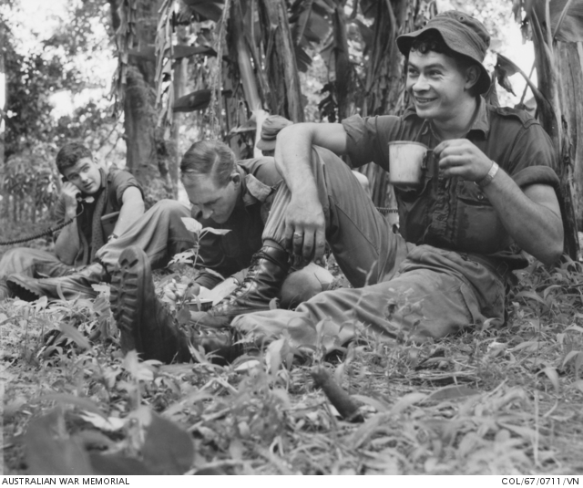 AWMemorial's tweet photo. Taken #OTD in 1967. Private Bob McMaster of Toora, Vic, enjoying a cup of coffee after a cordon and search in the village of Dat Do during Operation Burnside. With him is his commander, Major Ken Blayden of Floreat Park, WA (centre), and Private Peter Portell of Prospect, SA. https://t.co/EROUa84Qjr