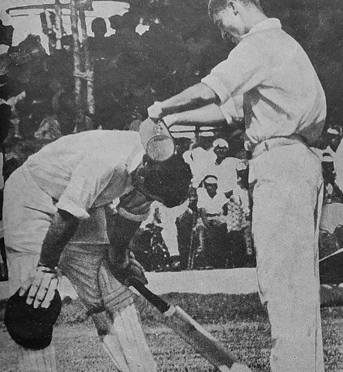 Australian 12th man Bob Cowper pouring ice water on captain Bob Simpson's head, Madras, October 1964