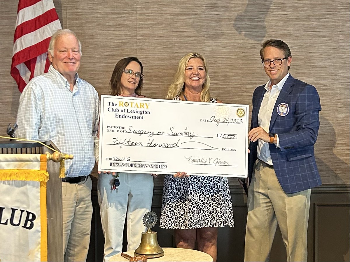 President Kim Johnson and #DWLS co-chair Bret Anderson present a $15k check to ED Meg Campos and founder Dr. Andy Moore of <a href="/SurgeryOnSunday/">Surgery On Sunday</a> #RotaryEndowment #serviceaboveself #changinglives