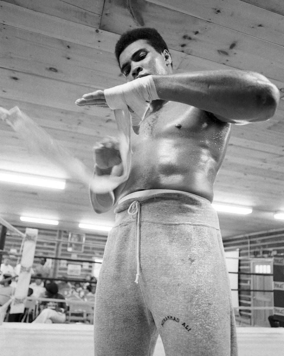 Muhammad Ali wrapping his hands during a photo shoot at in Deer Lake, PA. 📸: @LeiferNeil #MuhammadAli #TrainingCamp #Icon #DeerLake #HandWraps #NeilLeifer #Champion