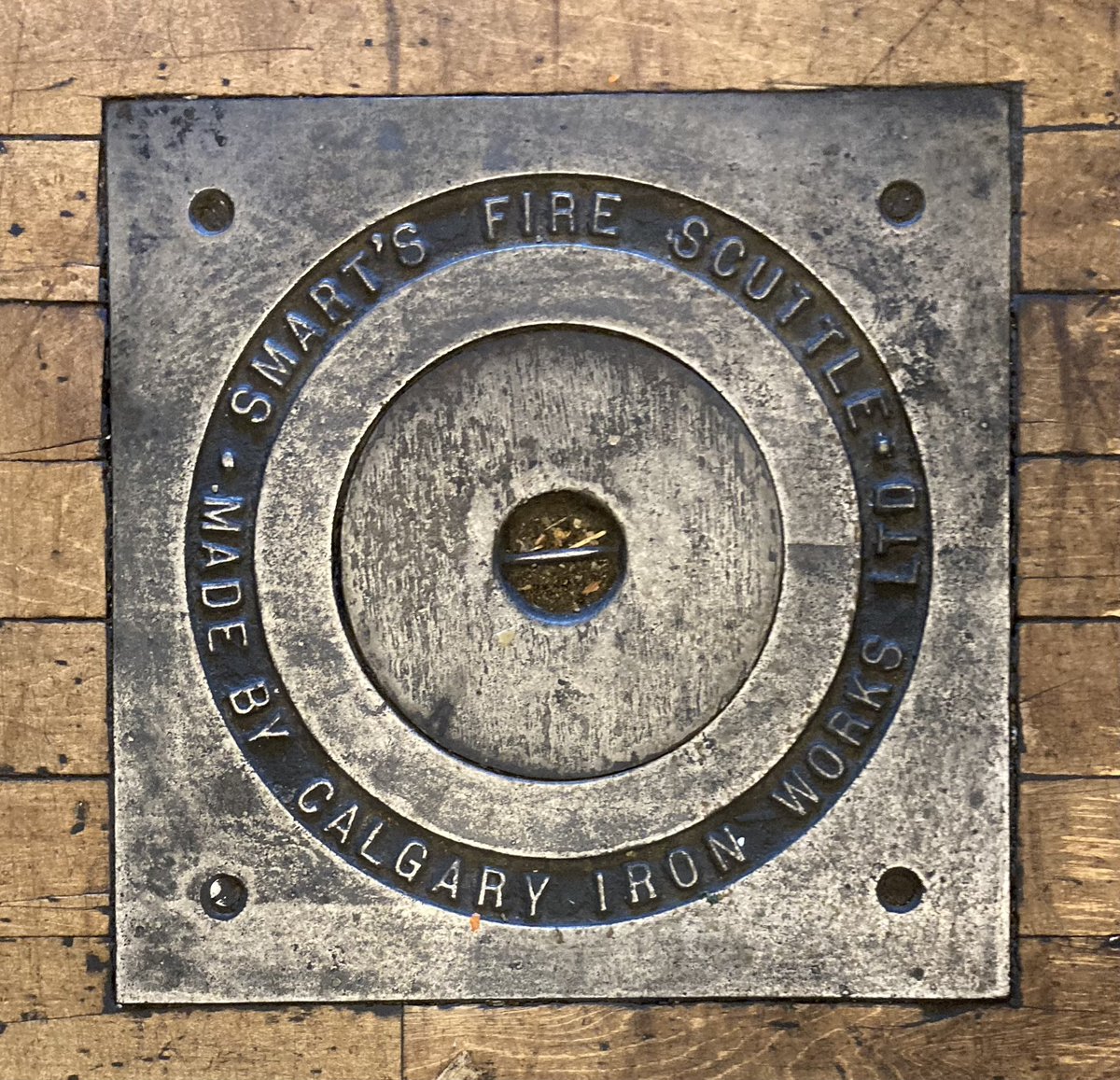 AlanZakrison's tweet photo. In 1907, Capt James Smart of the #CalgaryFireDepartment invented a fire scuttle.
It consisted of an iron aperture and cover, through which a revolving fire nozzle was inserted.
Useful in dealing with basement fires.
This one’s at @charbar_yyc, but others in #YYC have survived. https://t.co/9AcSrUPElO