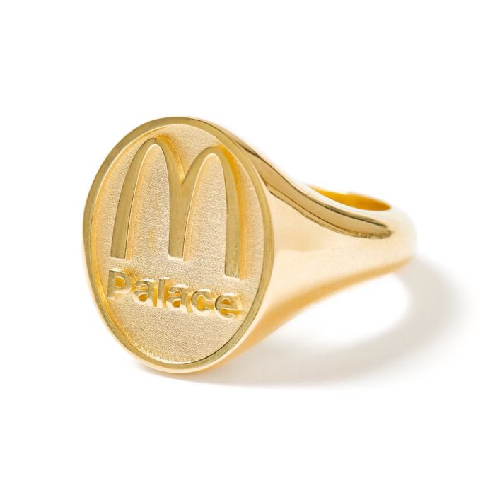 A golden Palace ring is pictured on a white background. The ring has the McDonald’s arches in the middle with the word Palace underneath.
