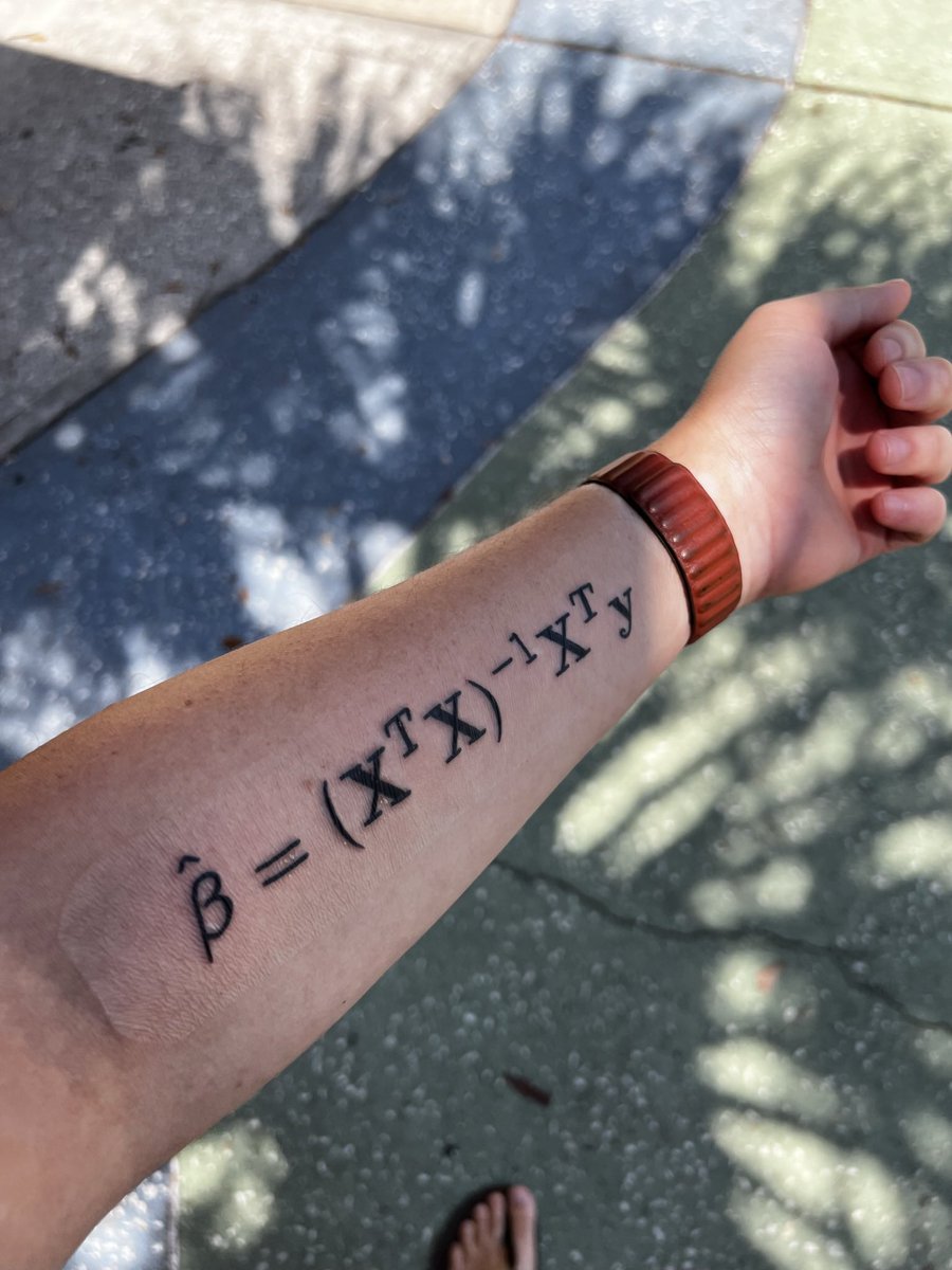 A picture of my forearm, showing a new tattoo of the equation for ordinary least squares regression