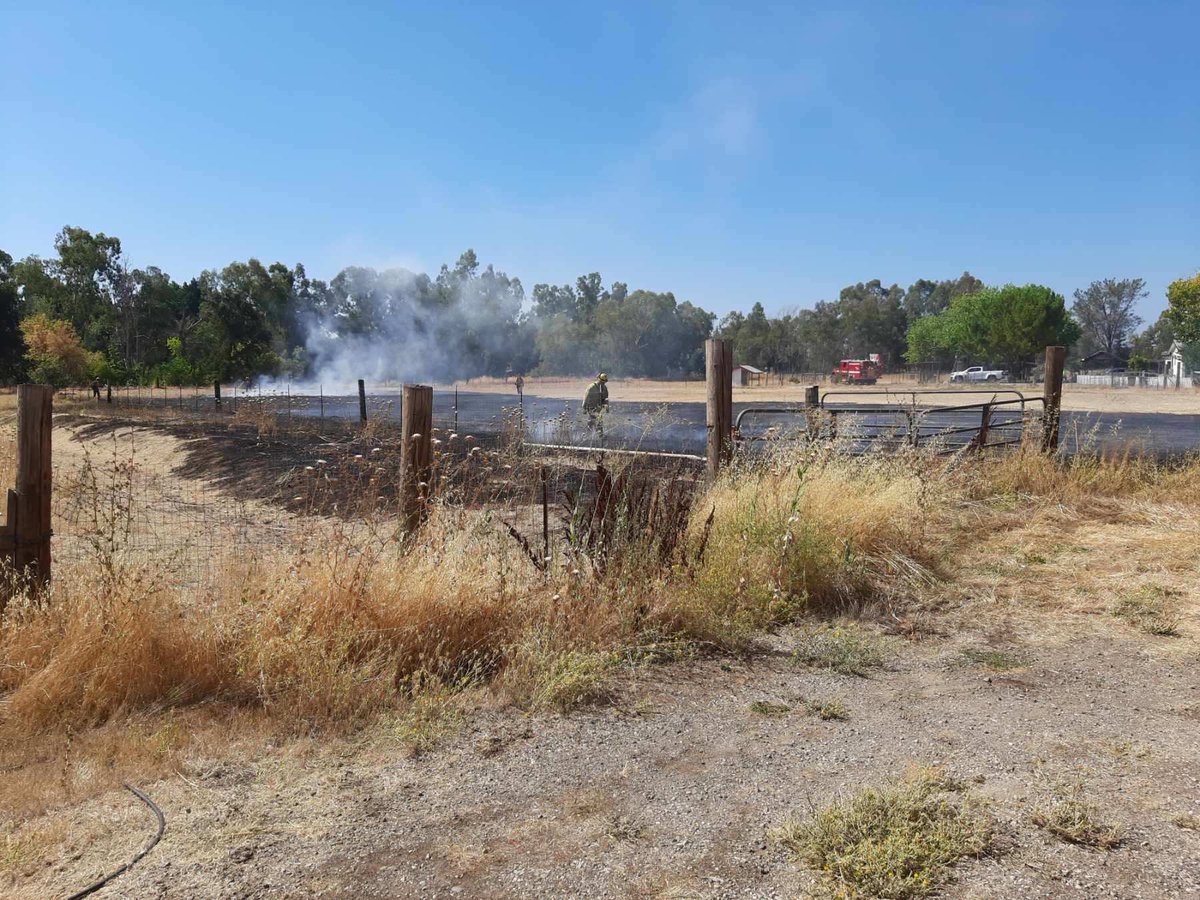 CALFIRE_ButteCo's tweet photo. Firefighters at scene of a vegetation fire in Nord off of Meridian road. 1/2 acre of grass, hose around fire. Resources will be at scene the next hour working on full containment and control #Kansasfire https://t.co/bbPfaCXmr7
