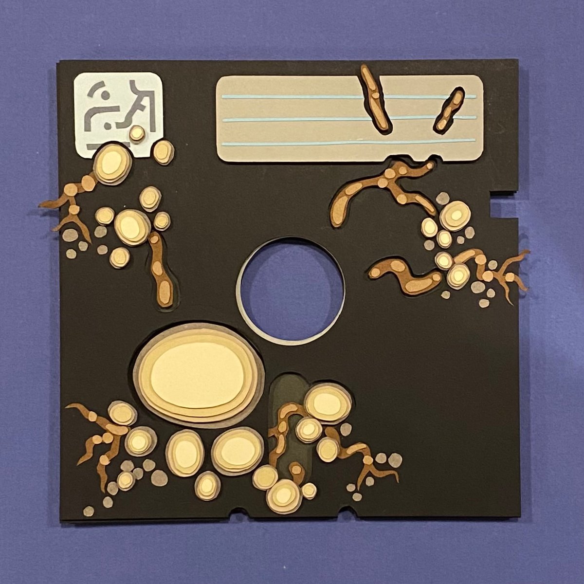 “RLQRY_013_C.IGS”, cardstock &amp; Xacto, 2023

“object in question appears to be a standard 5.5” floppy disk. brand is of unknown origin, temp label is unmarked. it is write-protected, and kept in glass-

disk is covered in an indeterminate fungus.”

#StilledEarth #paperCutting