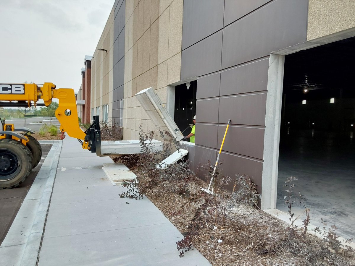 FabconW2E's tweet photo. How cool is this?! Check out these images of Settler's Ridge in Woodbury, MN. Our W2E crews were sawcutting and removing sections of the wall to allow the tenant new access to their space by cutting a 12'x14' OH door in the panels. #ThinkFabcon https://t.co/m9HBZnGiLR