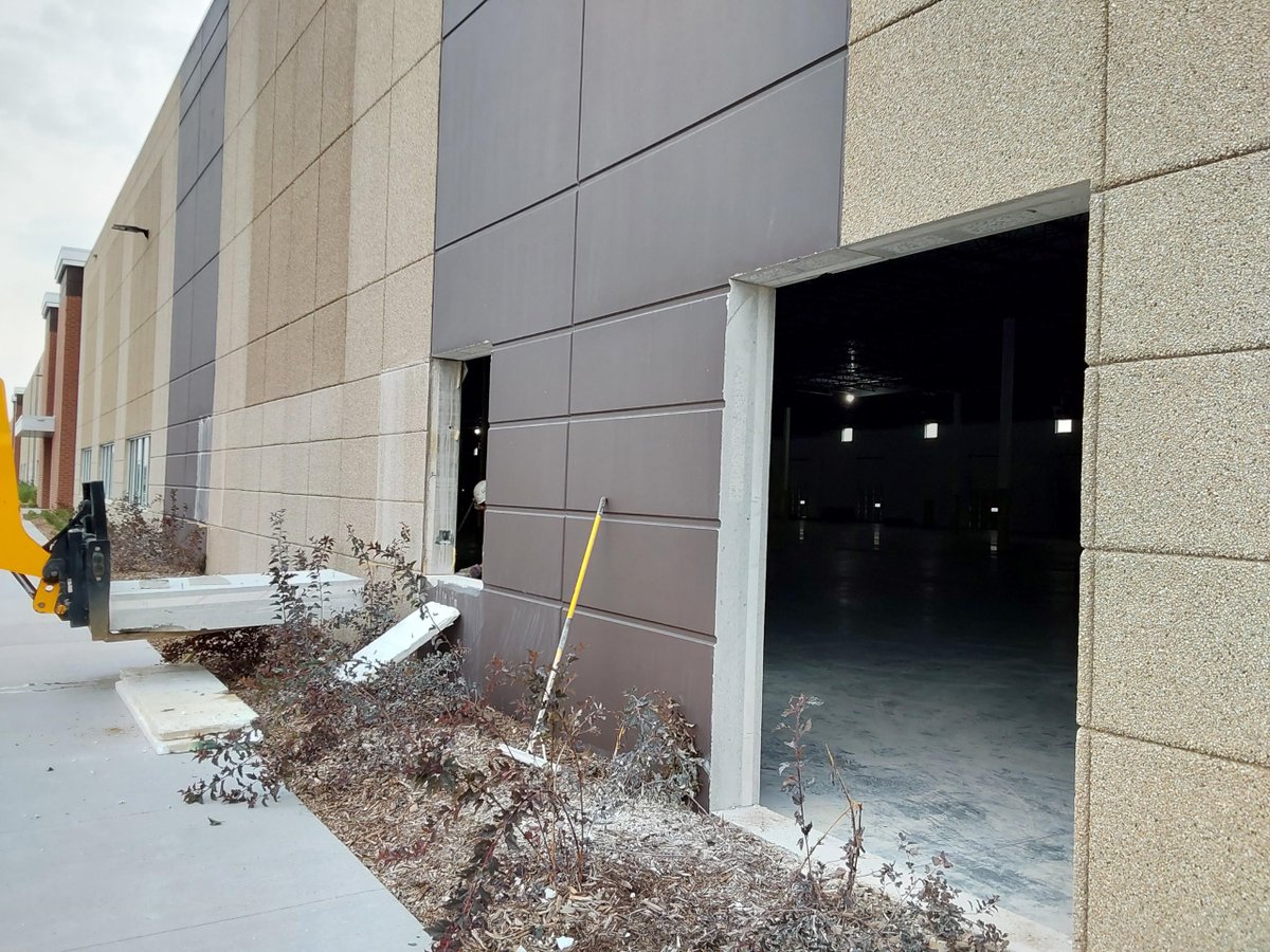 FabconW2E's tweet photo. How cool is this?! Check out these images of Settler's Ridge in Woodbury, MN. Our W2E crews were sawcutting and removing sections of the wall to allow the tenant new access to their space by cutting a 12'x14' OH door in the panels. #ThinkFabcon https://t.co/m9HBZnGiLR
