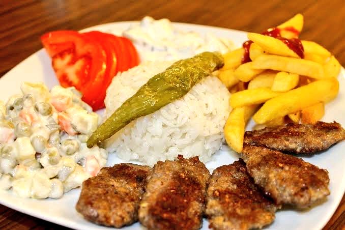 Soldaki Bosna Hersek'ten bir köfte tabağı. Kaymak ve soğanla servis edilir. Ekmeği ince ve hafiftir. En az 200 gram et içerir fiyatı ise en salaş mekanda 2,5 Euro, Ferhatović veya Brajlović'te 3,25 Euro 3,5 euro civarıdır. Sağdaki de bizdeki köfte menüdür. 120 gram et içerir.