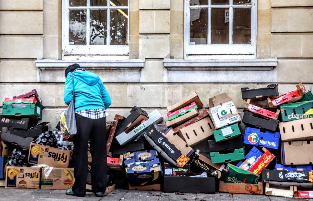 London Views - E17 13/07/2023 - #04/#05: Slim Pickings A sad reflection of life seen outside Walthamstow Library. Street traders pile their unwanted cartons and boxes, for collection later in the day, where this lady was searching discarded fruit.