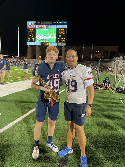 AllenBand's tweet photo. Did you know the Allen Eagles Varsity kicker, Brayden Nelson, is also in the band? We love that Dr. Obado was wearing Brayden's jersey at the game last night!

We are a community that supports our students being able to enjoy all their activities! A-Up! https://t.co/jSxiv35CqO