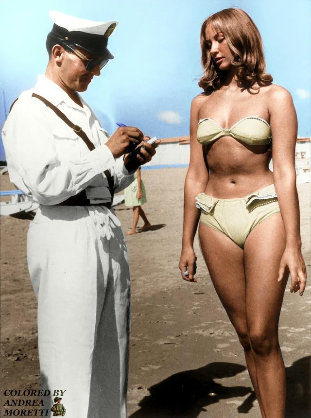 [Colorized] A traffic cop fines a woman for wearing a bikini. Rimini, Italy, 1957