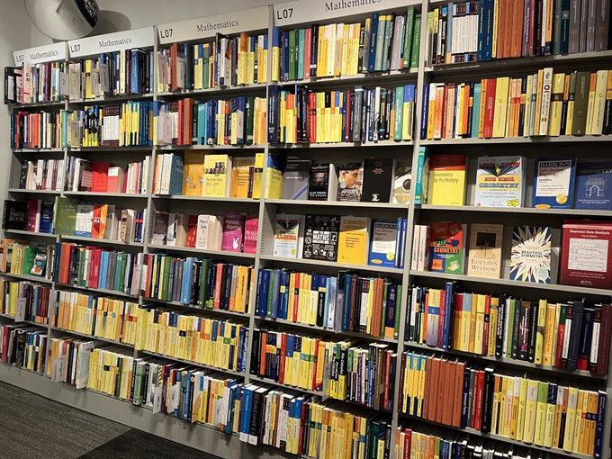 A wall full of mathematics books extending to the left …