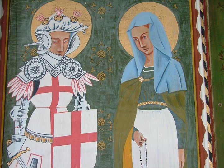 SimoninSuffolk's tweet photo. Today's the feast of St Monica, the 4th Century North African mother of the wayward St Augustine. Here she is, deep in conversation with St George on the reredos at East Barsham, Norfolk. Often presented as a model of patience and piety, she is the patron saint of difficult marriages and those with disappointing children.