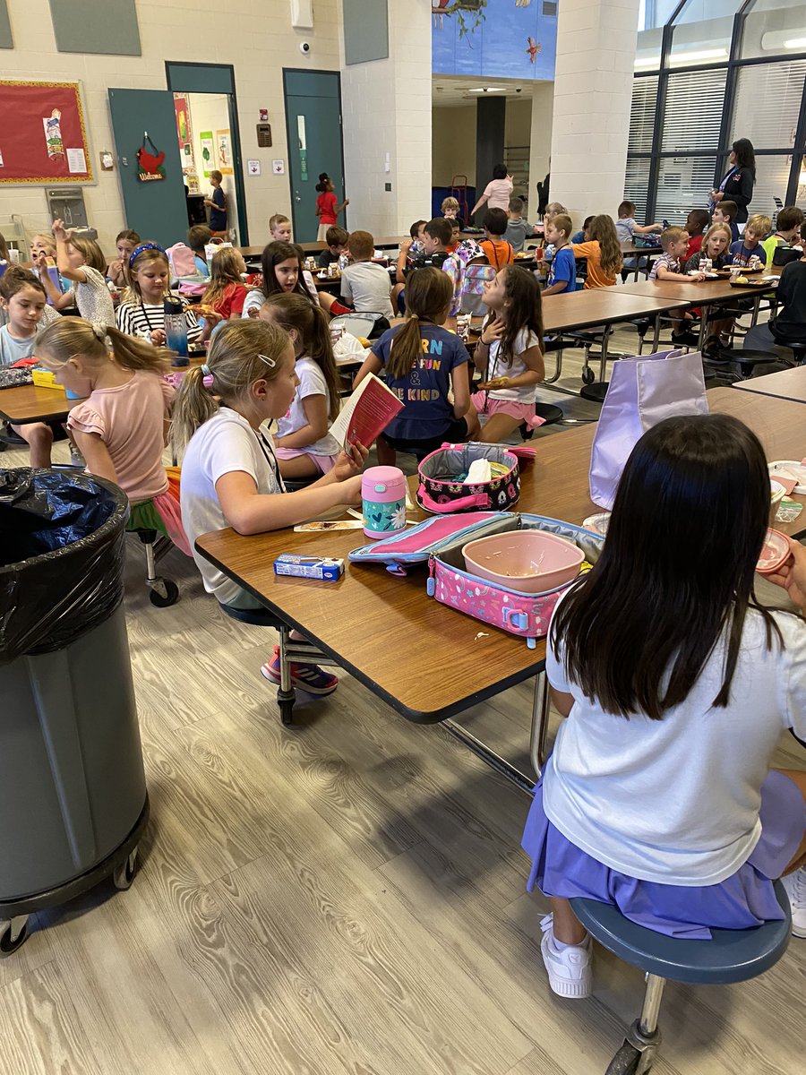 I just love this!  Amidst the chaos of lunch duty- I spy a sweet little girl quietly reading her book while eating. Reading truly is an escape and I love it when kids love to read!  <a href="/HumbleISD_WCE/">Willow Creek Elem</a>
