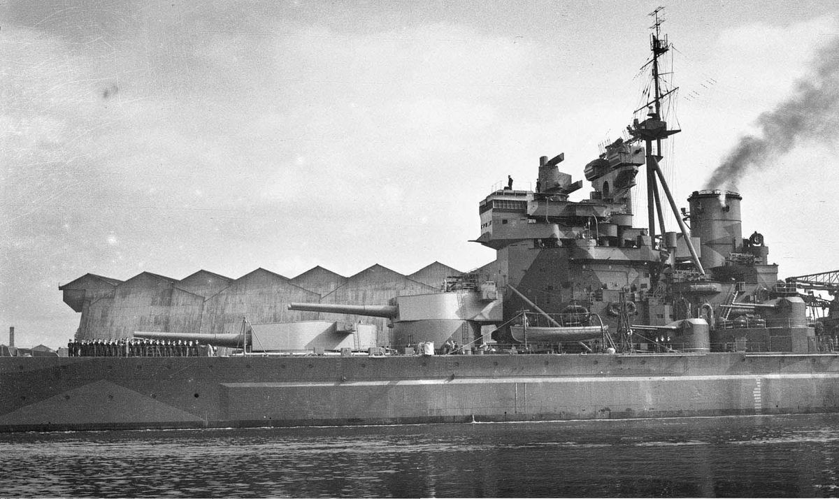 Battleships as buildings is an underappreciated genre. Here is Duke of York with a more subtle take - but note how her paintwork matches the buildings ashore behind her!