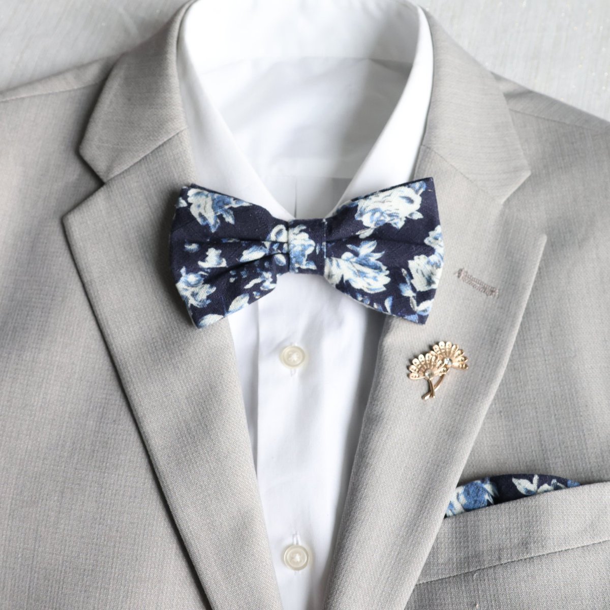 Petals and patterns – a floral bow tie for those who embrace the beauty of details. #bowtie #bowties #weddingtie #weddingties #bluebowtie #bluebowties #groomsmentie #groomstie #menswear #mensfashion #portlandwedding #portlandweddings #groomsmenstyle #groomsmenoutfit #bluewedding