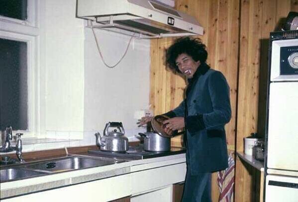 Jimi Hendrix cooking dinner at his apartment, 1969