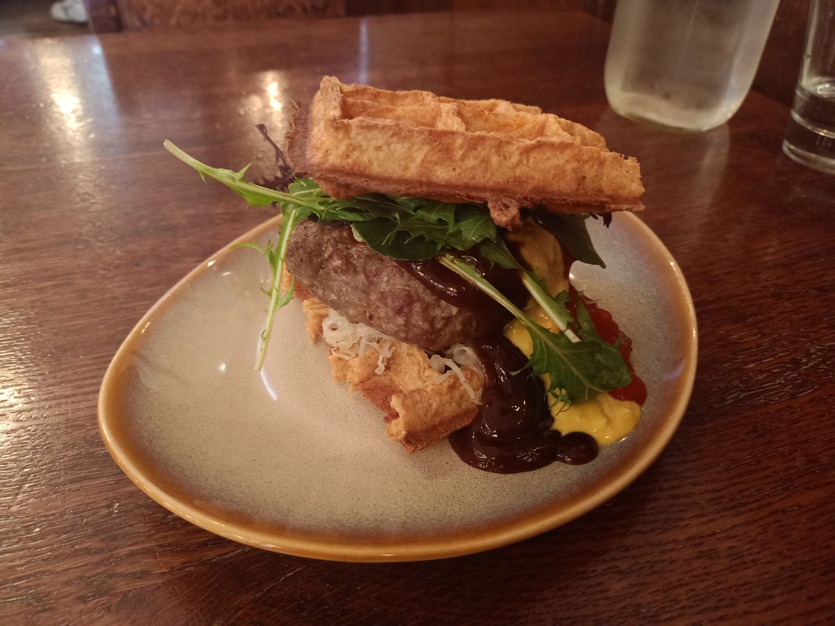 DissidentZero's tweet photo. Leuven - A Load of Waffle
A novelty 'waffle Patty' with a bit of sauerkraut between savoury waffles, the taste profile ended up quite good, but the waffles were slightly overcooked, the novelty patty wasn't waffled, and they were all out of Waffle fries. Tasty, but 🙁 https://t.co/O4hbmJm9tf