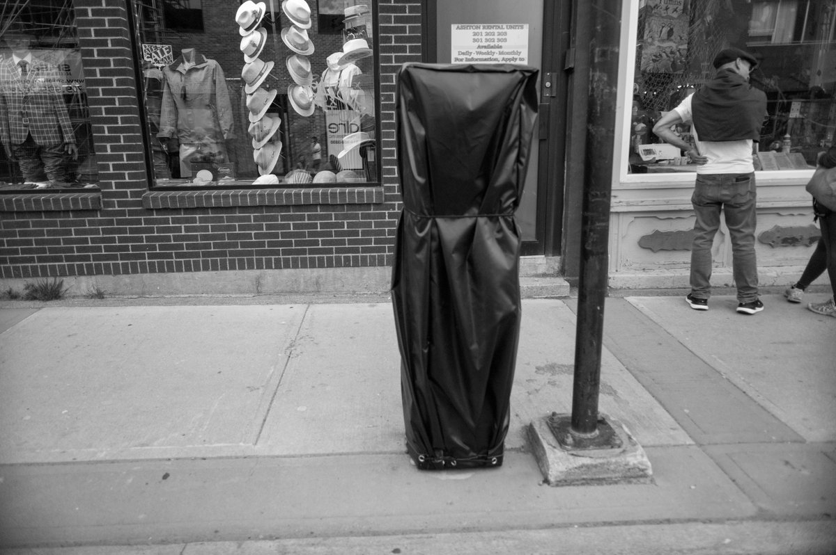 St. John's Newfoundland. That's a parking ticket machine under the tarp--at least I hope so. (@leica_camera M Monochrom, the original one, 35mm f1.4 Summilux)