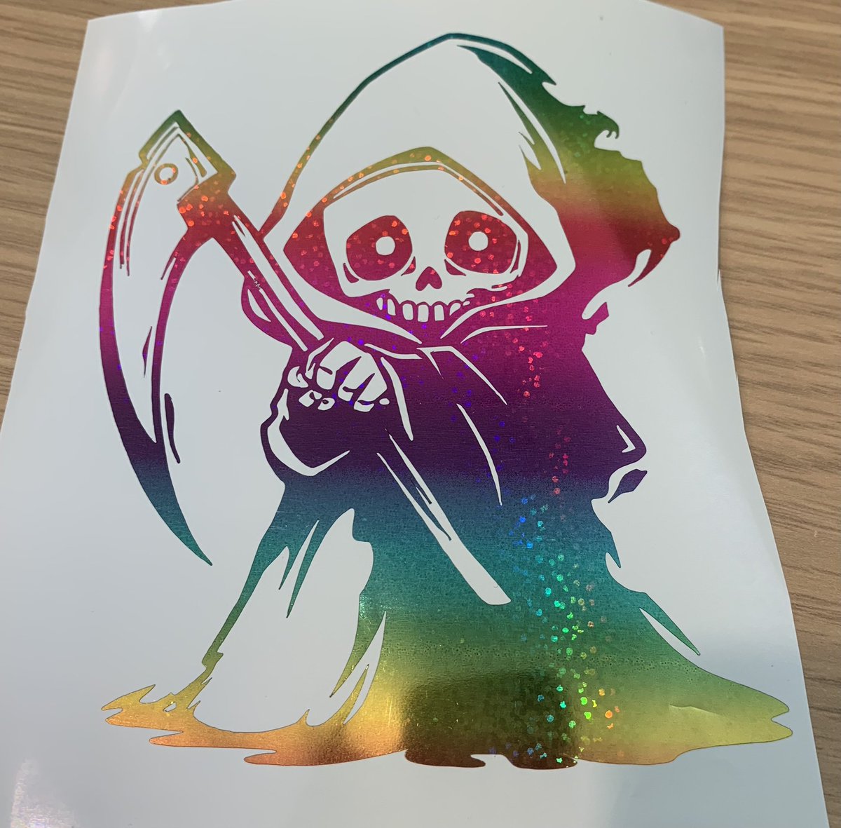 Our cute grim reaper decal in our rainbow vinyl for an order cut at 5 inches #rainbow #vinyldecal #mhhsbd #decal #grimreaper #order