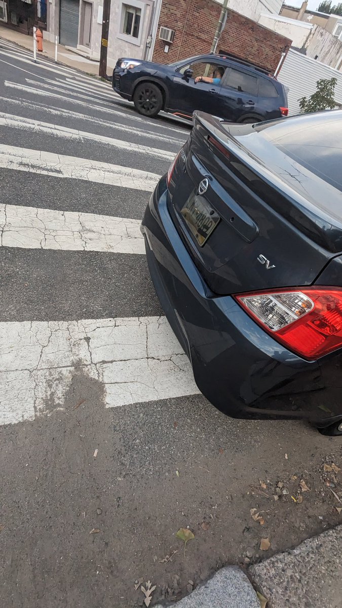 mr_saltz's tweet photo. SMH another #DrivingEquity fail. This criminal was bold enough to park in a crosswalk with an illegal license tint and a 12th District PPD placard right outside a police station. Getting bolder, thanks libs https://t.co/nXtKpqy6zs