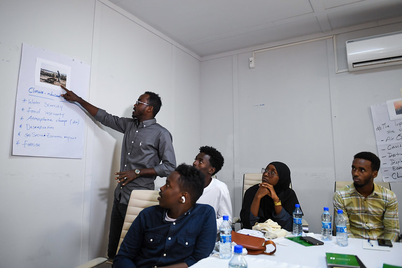 UNSomalia's tweet photo. A three-day, @UN-backed training on the links between #humanrights and #climatechange in #Somalia began today in #Mogadishu - participants examined how changing climate patterns lead to food insecurity, conflict over shrinking resources and displacement; and how climate change's consequences especially affect #women, persons with disabilities, children and marginalised groups.