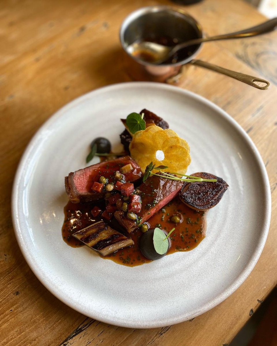 Gorgeous dish of 50 day dry aged native beef sirloin, BBQ short rib, smoked onion, aubergine and nasturtium from @thekentishhare bit.ly/3O78W4K