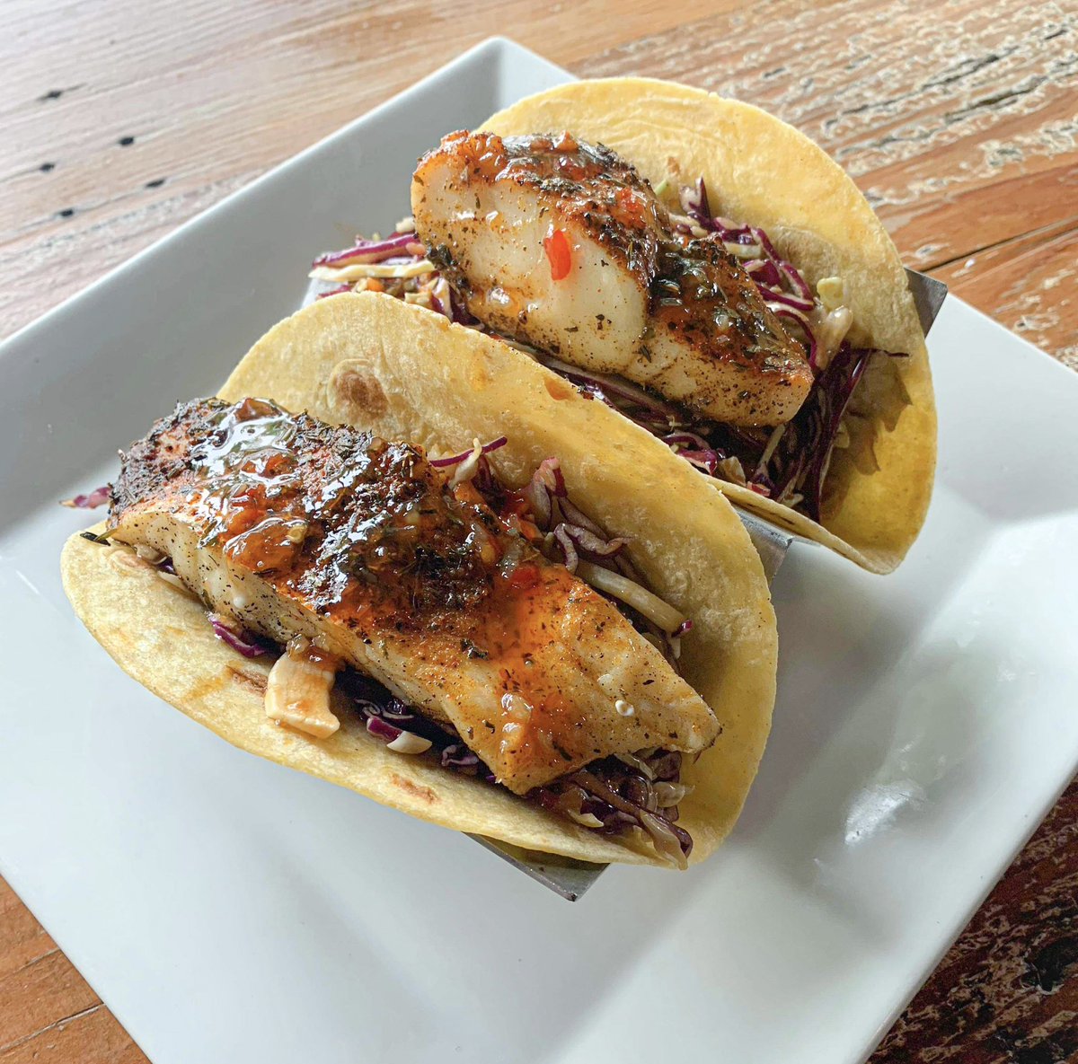 🌮Taco Tuesday!🌮
Blackened fish tacos on a bed of hoisin slaw, topped with sweet chili! 
2 for $9 🤩