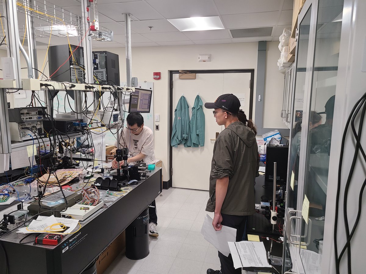 08/18/2023
Meiting and Jiewei showing the attendees of the AIM Photonics PIC Testing and Packaging Workshop how to align a PIC to a 12 fiber array to measure loss, characterize an interferometer, and use an on-chip detector. <a href="/RochesterOptics/">Institute of Optics</a> <a href="/AIMPhotonics/">AIM Photonics</a>
