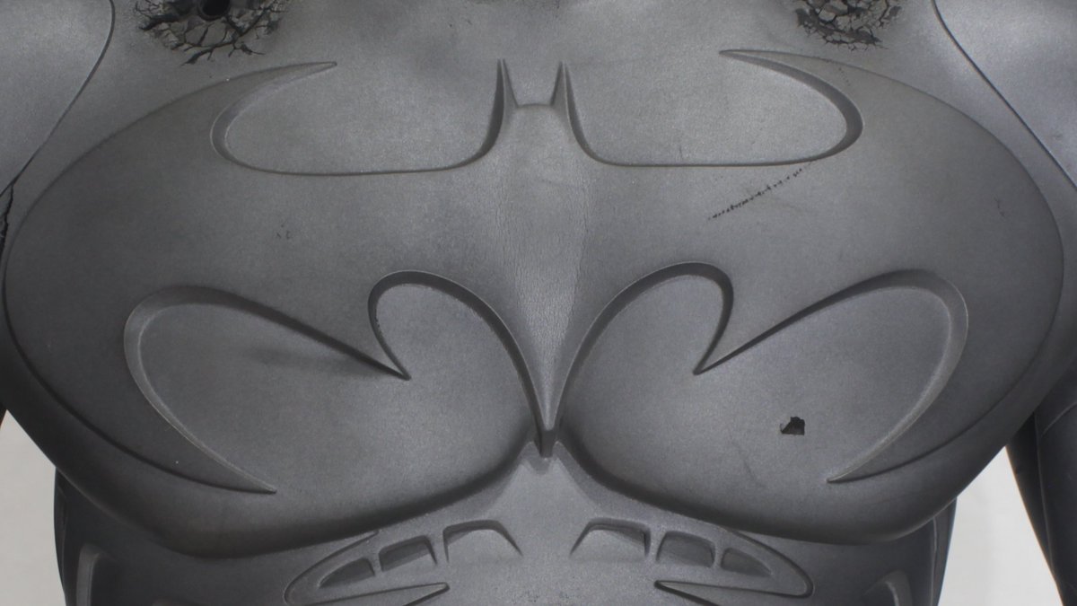 Close up Photos of the Chest Emblem form the Sonar (Bat)Suit from Batman Forever. This suit swaps out the Yellow Oval from the Panther Suit (&amp; previous movie batsuits) for a big wide bat that spans both his Pecs. While I do prefer the Yellow Oval, the wide bat here looks awesome.