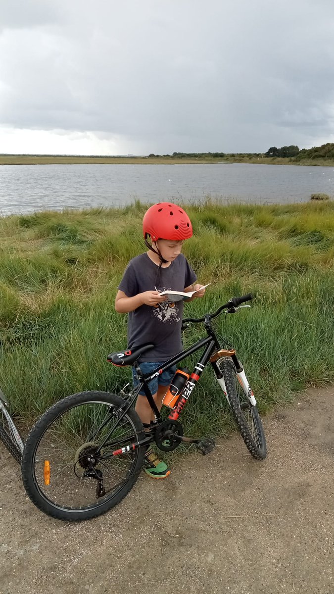 CNuttl's tweet photo. @SandwichJunior 
Benjamin enjoying a well earned rest and read during  an epic bike ride #somewherebythesea #SJSSummerReadingChallenge https://t.co/leV9inat9c