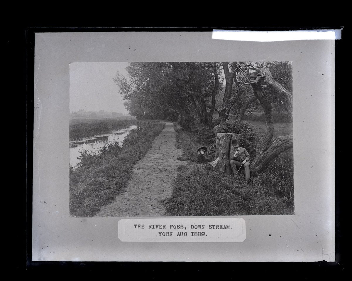 It's a beautiful August day here in York, perfect for a stroll by the river. This image of a glass plate negative shows a man and a girl sitting by the River Foss in August 1889. #riverfoss #sunshine