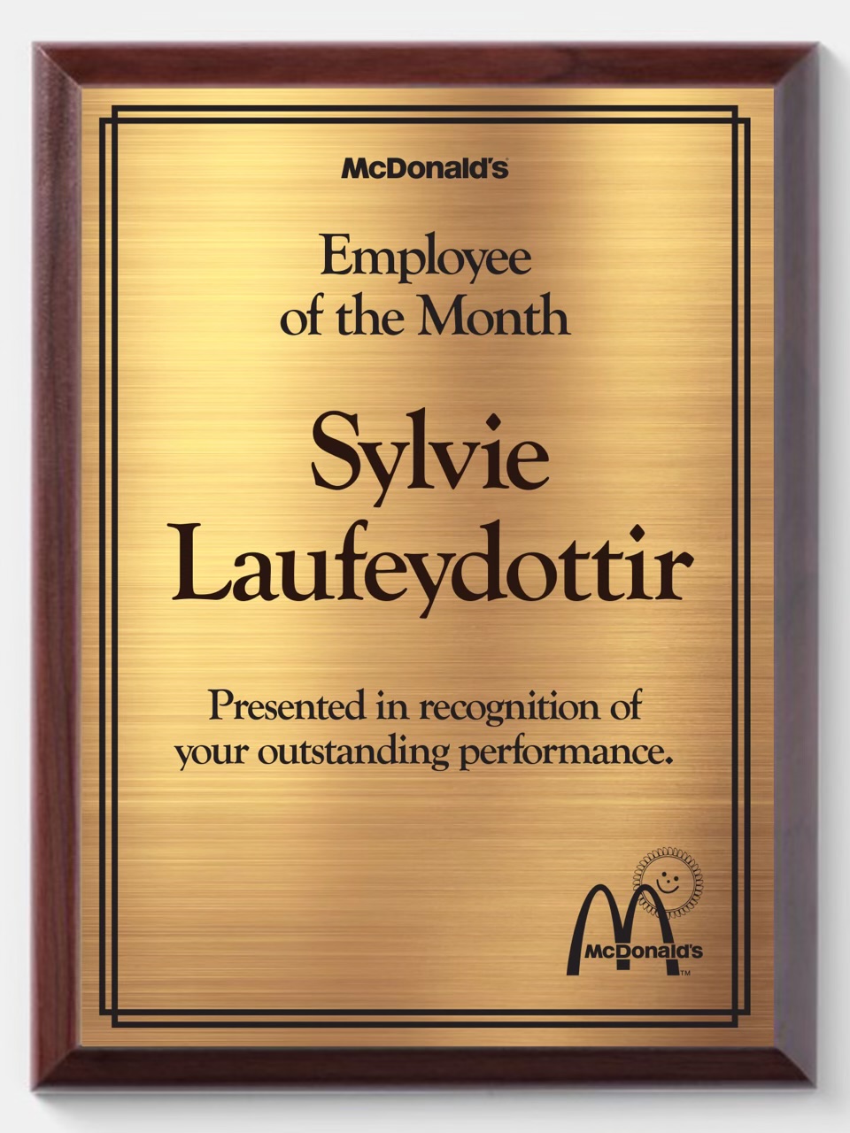 McDonald's employee of the month plaque celebrating Sylvie for her Achievements.