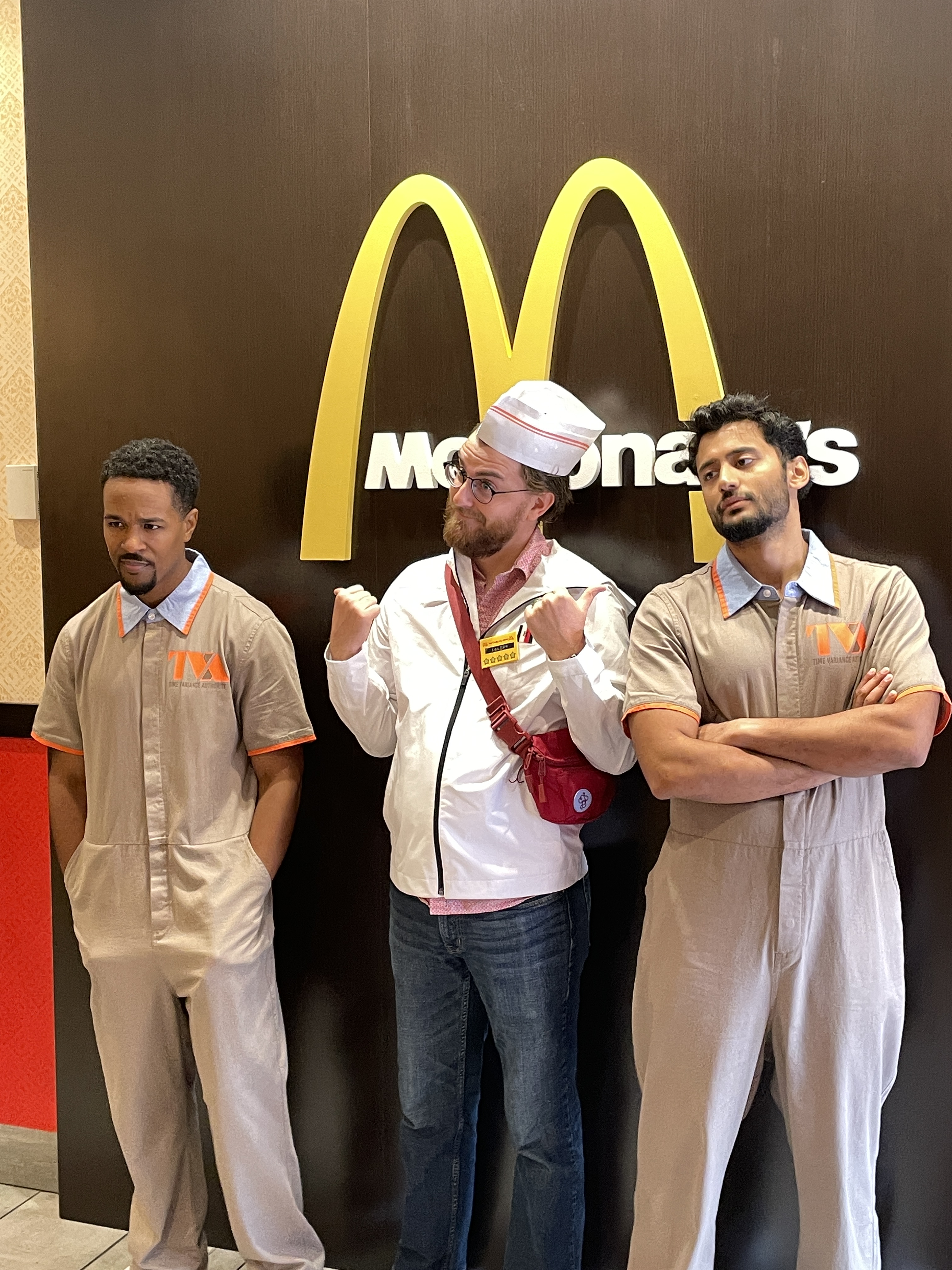 Group picture including 2 TVA Prisoners in front of a mcdonald's logo