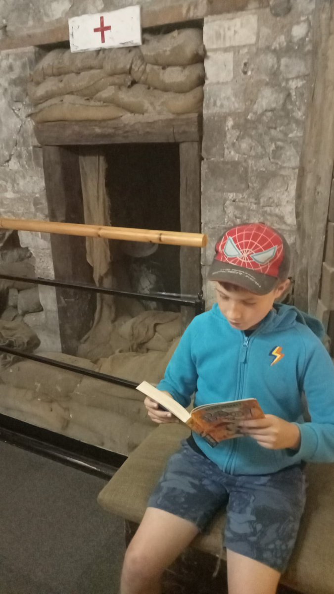 CNuttl's tweet photo. @SandwichJunior 
Benjamin reading in a WW1 bunker at Dover Castle 
#somewherelow #SJSSummerReadingChallenge https://t.co/IrAbU9tcdS