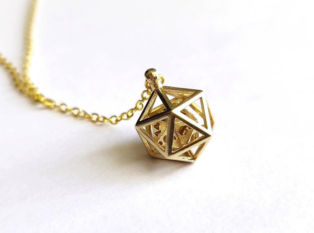 Want to keep a D20 close to your heart at all time? How about a subtly nerdy necklace with a very small D20 in a matching cage! The D20 can roll freely within the cage! 3D printed so the charm is forever intertwined.