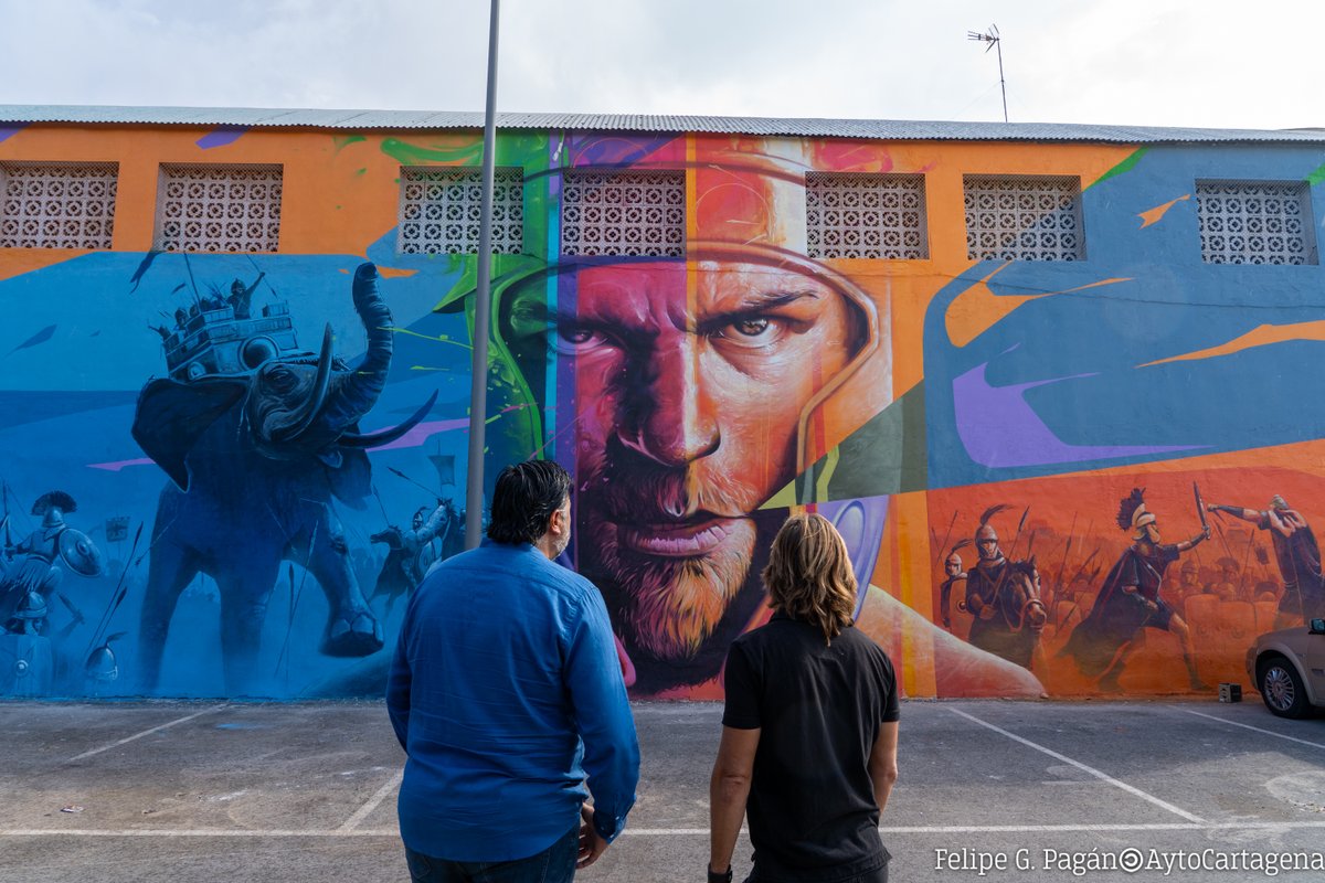 AytoCartagenaES's tweet photo. 📌Un mural de pintura de #Goyo203 representa la batalla de @CyR_Cartagena frente a la Cuesta del Batel de #Cartagena.

⚔️El artista representa la batalla de Aníbal y la parte romana en el mural, resaltando la importancia de esta épica confrontación.

ℹ️ https://t.co/7RnNtt4Q48 https://t.co/q7fZWL4fXe