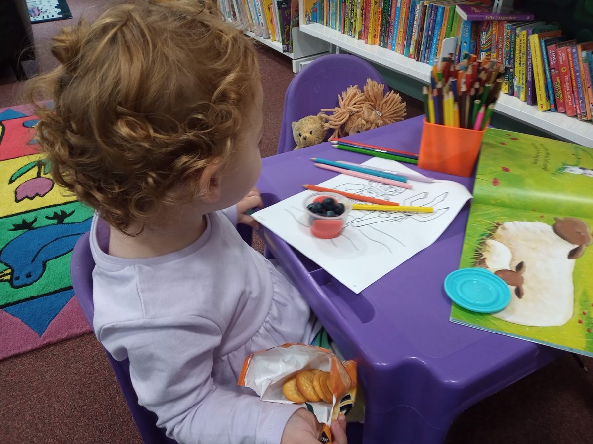 @rebeccalangtonn @NottmLibraries And here she is. Multi-tasking in Bilborough library - reading, colouring, educating her teddies and eating!