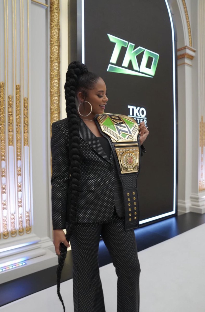 WrestleOps's tweet photo. Bianca Belair poses with the ‘TKO’ Championship to symbol the merger between WWE &amp; UFC today. https://t.co/yTsyJOSLJe