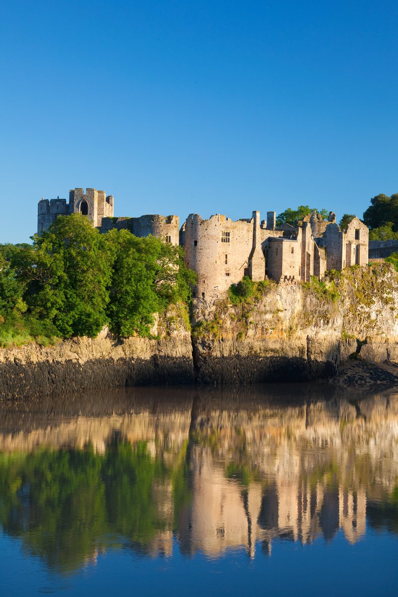 Chepstow Castle on the cliffs above the River Wye, with its mirror image in the reflection below.

A beautiful shot here highlighting just how much the castle clings to the cliffside, with the walls rising up almost as an extension of them.

#lovemonmouthshire
