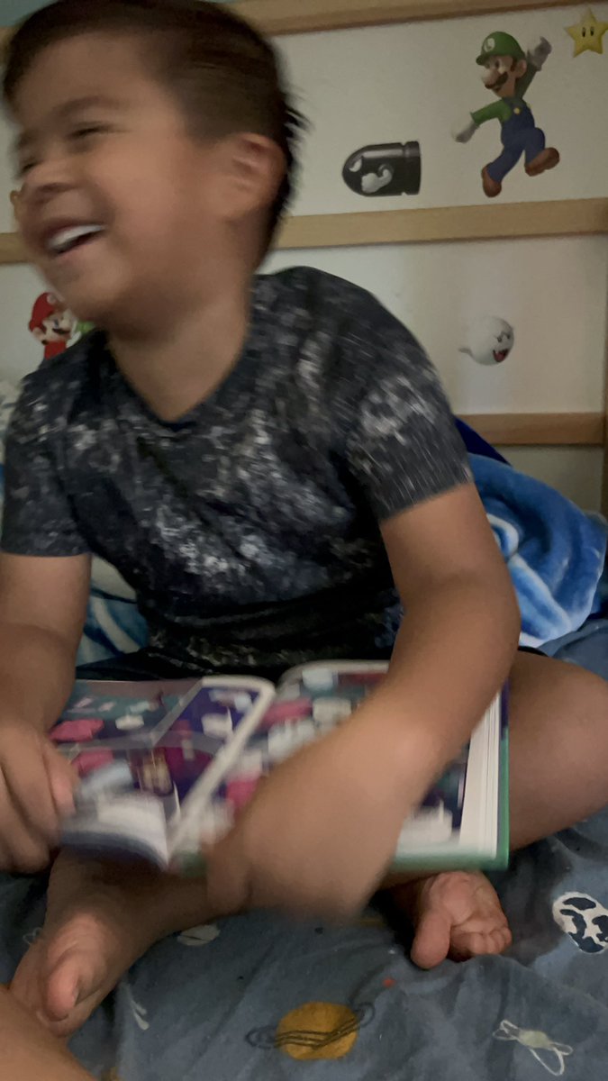 KariPleitez's tweet photo. @MeggietheRamm My 6 year-old loved Batcat, as evidenced by this blurry photo of him joyfully reading it 🤩 He said he can’t wait for the next one! We hope there’s a next one! https://t.co/vtxm6Y57sJ