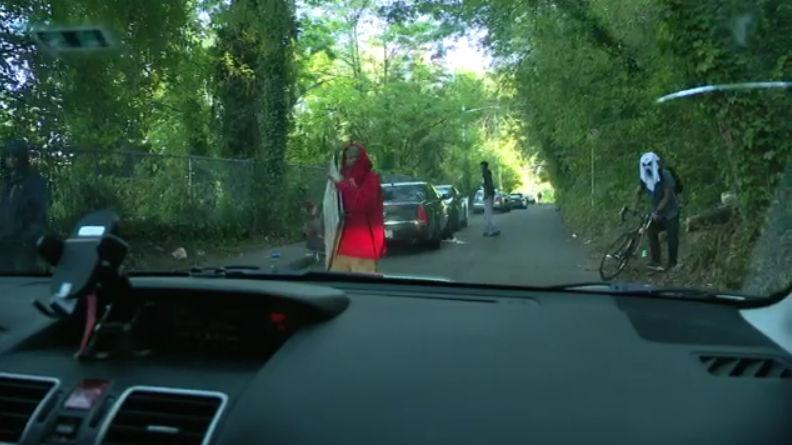 HannahknowlesTV's tweet photo. TODAY: My photographer and I were approached by these two men at the camp while we were INSIDE our vehicle. The man in the red is holding a 'No Parking' sign which he attempted to hit our car with. #Seattlehomeless #BeaconHill https://t.co/q68TVTBnyC