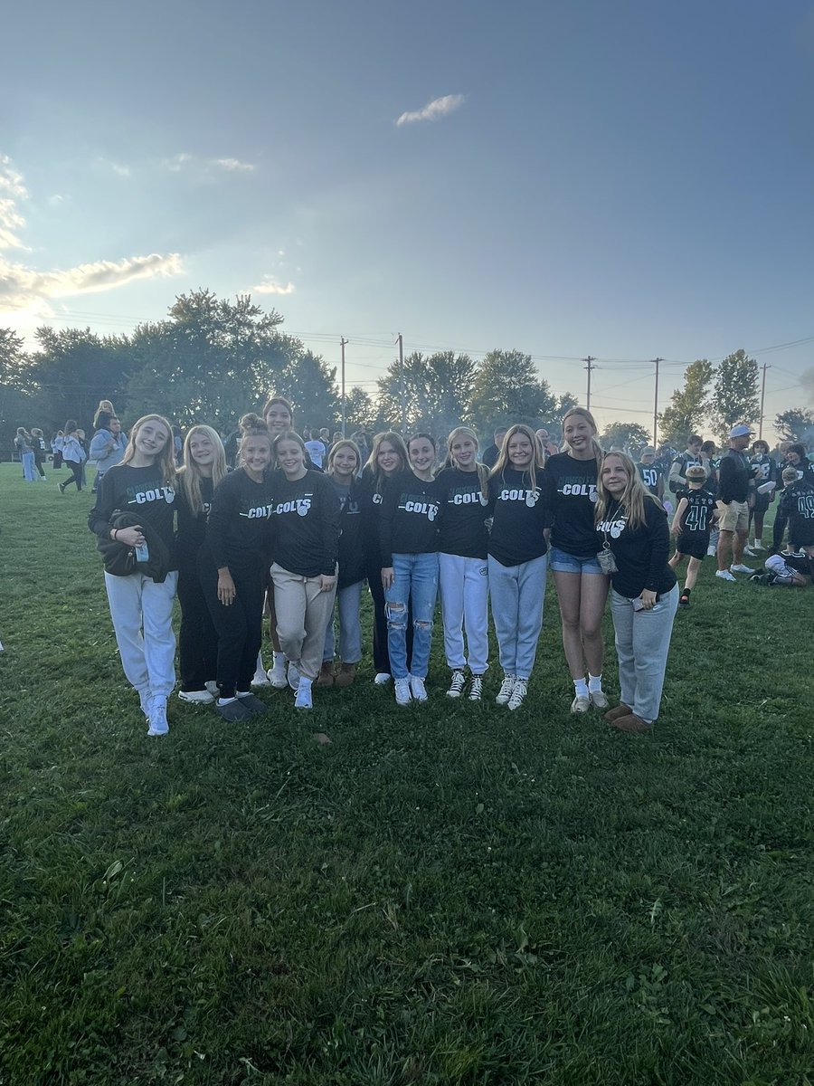 Volleyball seniors being recognized at the homecoming bonfire and their teammates cheering them on!