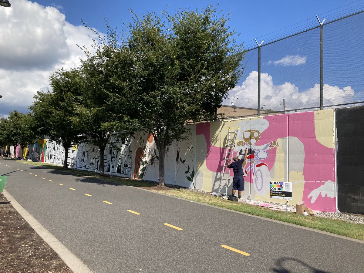 wmata's tweet image. Hurry! Only a few days left to see the NoMa in Color Mural 🎨 at Alethia Tanner Park along the Metropolitan Branch Trail. Catch the artists in action until September 15th. #artintransit #NOMABID #wmata