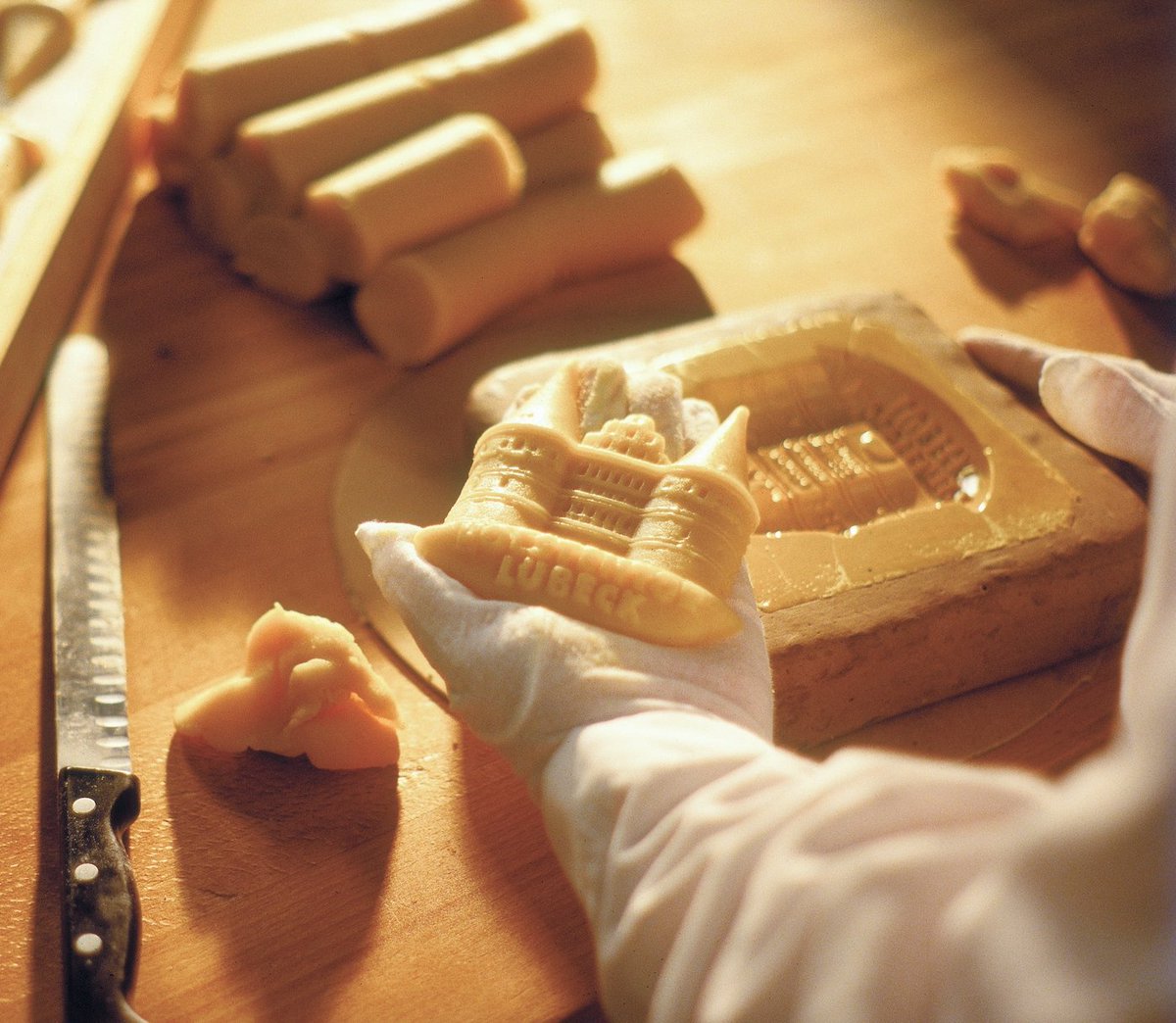 One of our artisan workers at our factory creating a mould of the Holsten Gate, which is the city gate marking off the western boundary of the old centre of the Hanseatic city of Lübeck where our famous cafe is!

#holstengate #niederegger #marzipan #travel